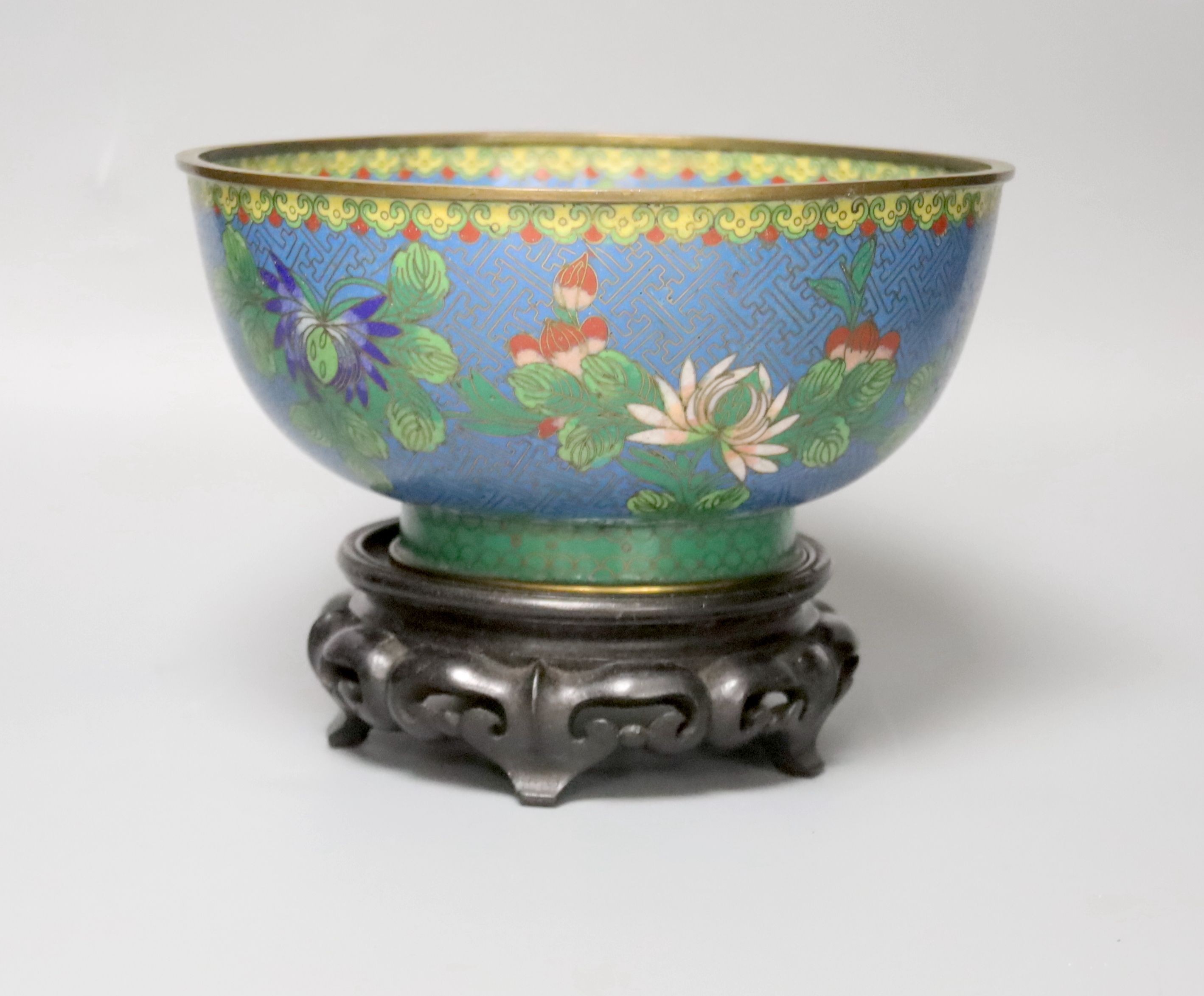 An early 20th century Chinese cloisonne enamel bowl, wood stand 20cm